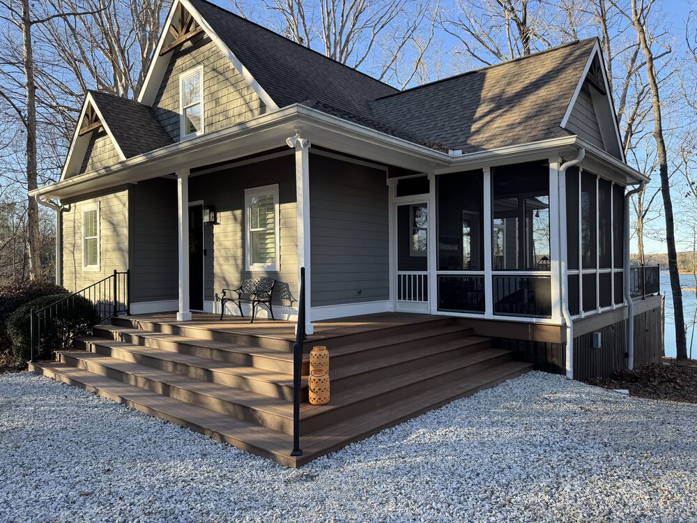 Beautiful newly built L-shaped wood stairs with 5 treads and metal railing.