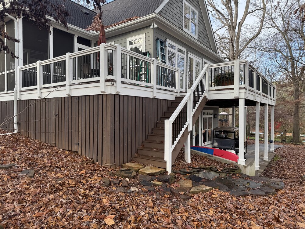before of deck on back side of lake house with white trim railings, old stairs