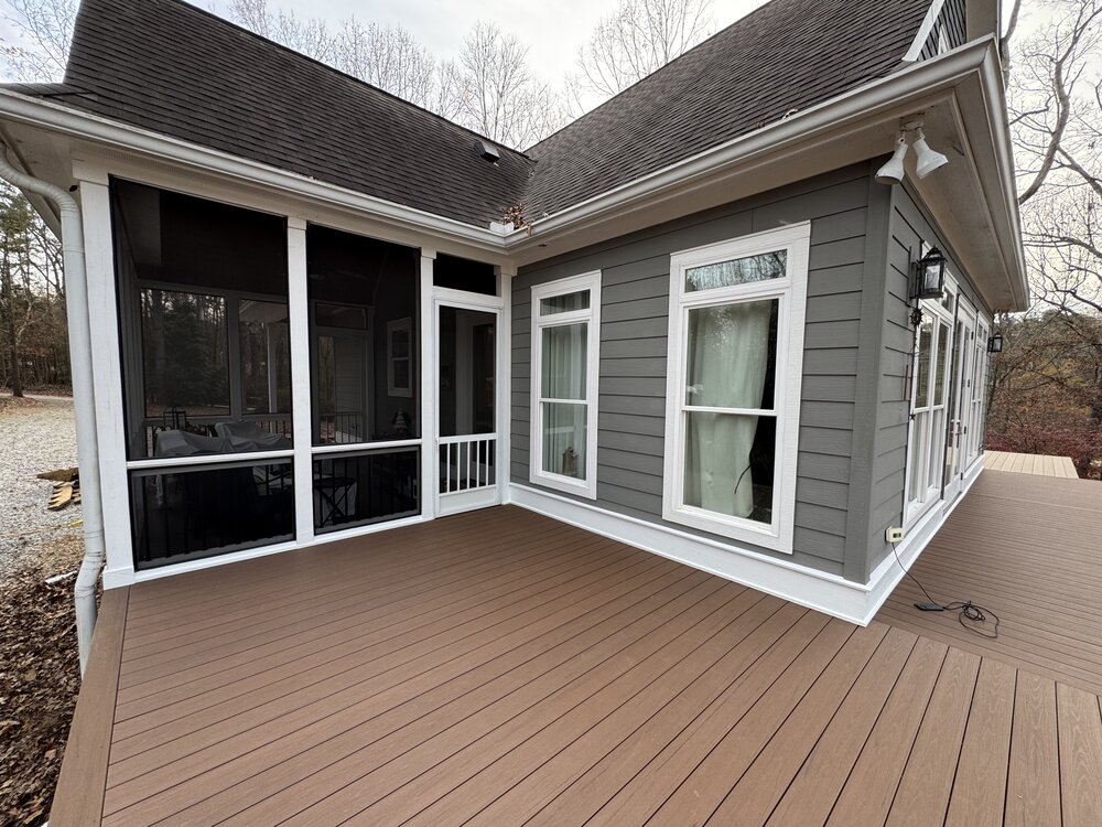another secition of house has newly laid deck flooring, and corner shows precision-cut edging to meet another section