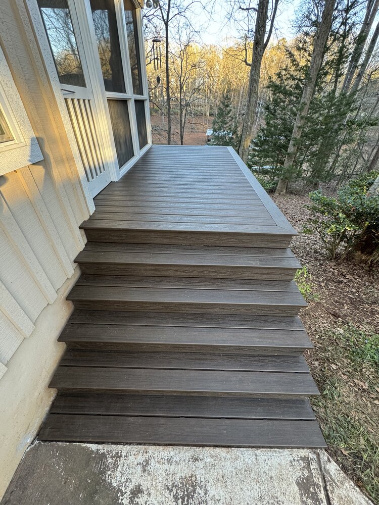 another secition of house has newly laid deck flooring, and corner shows precision-cut edging to meet another section