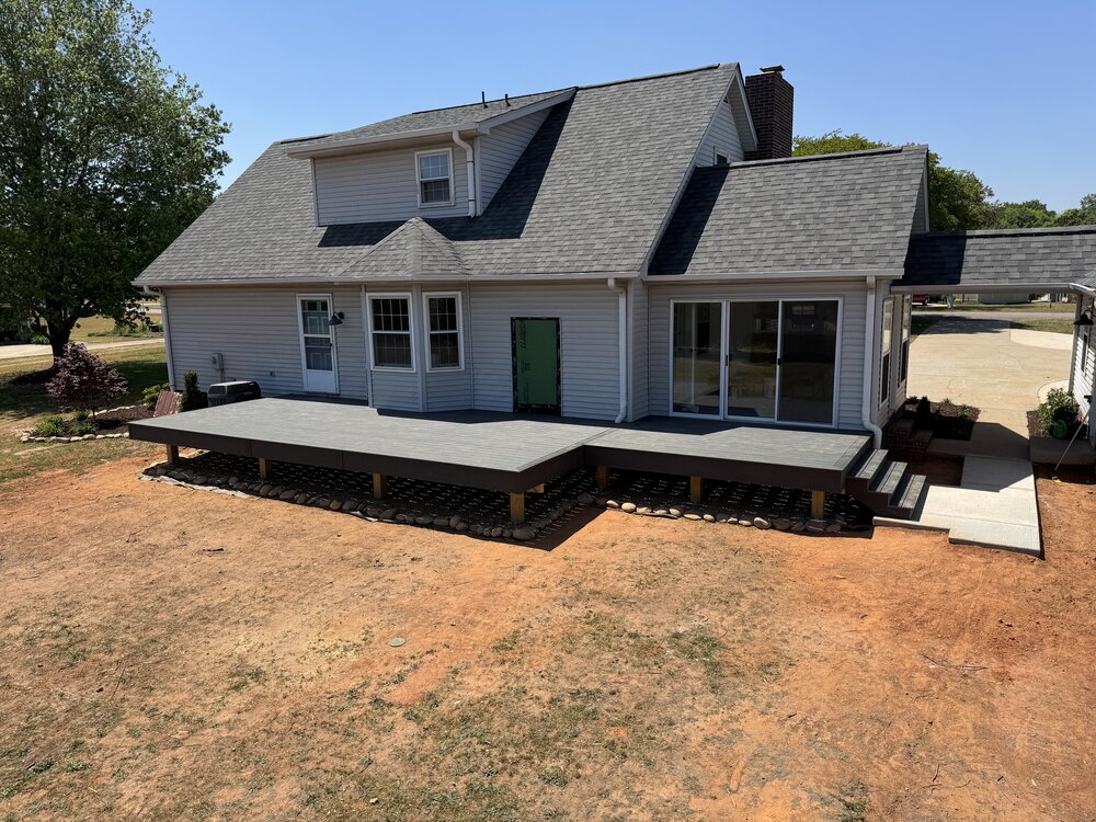 Arial view of the completed deck with Trex Decking with the house behind it.