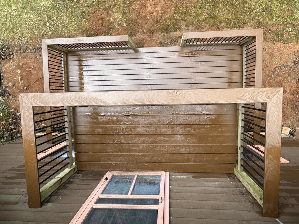 Top down view of the finished deck of the cabin, showing the new Trex deck with aluminum picket railings and elegant design.