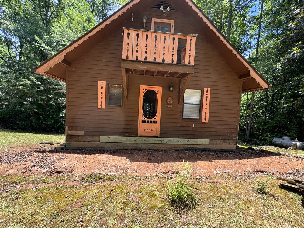 Progress view of deck completely removed to bare dirt.